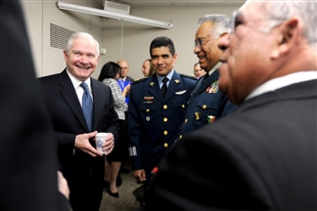 Secretary of Defense Robert M. Gates speaks with Secretary of National Defense of Mexico Gen. Guillermo Galvan Galvan (2nd from right) and Secretary of the Navy for Mexico Adm. Mariano Francisco Saynez Mendoza (right) through their interpreter (center) prior to the start of the U.S./Mexico High Level Consultative Group meeting hosted by Secretary of State Hillary Clinton at the State Department in Washington, D.C., on April 29, 2011.  