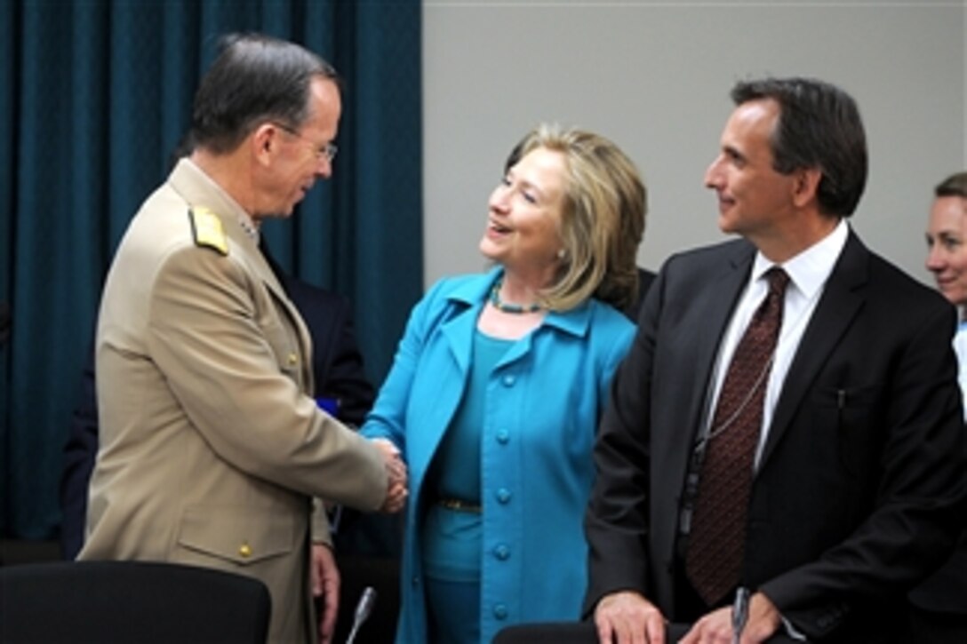 Secretary of State Hillary Clinton greets Chairman of the Joint Chiefs of Staff Adm. Mike Mullen at the start of the U.S./Mexico High Level Consultative Group meeting hosted by Clinton at the State Department in Washington, D.C., on April 29, 2011.  