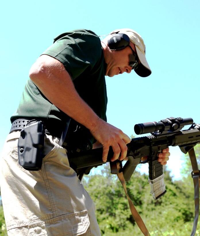 Gunnery Sgt. William Kevin Walker, a veteran of the U.S. Marine Corps Reserve Pistol Shooting Team, reloads his rifle during the Blue Ridge Mountain 3-Gun Championship here April 29.