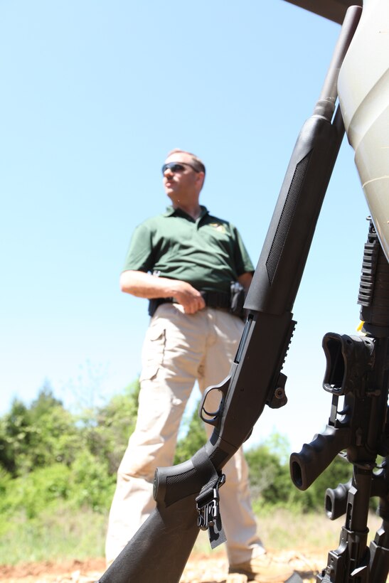 First Sgt. Clark Rhiel, the staff noncommissioned officer in charge of the U.S. Marine Corps Reserve Pistol Shooting Team, awaits his turn to shoot in a three gun event at Park City, Ky., April 29, 2011.  As chief instructor at the Reserve combat marksmanship trainer school in Marine Corps Base Quantico, Va., Rhiel and other members of the pistol team participate in various shooting events in order to learn about different aspects of shooting and take the knowledge back to students.