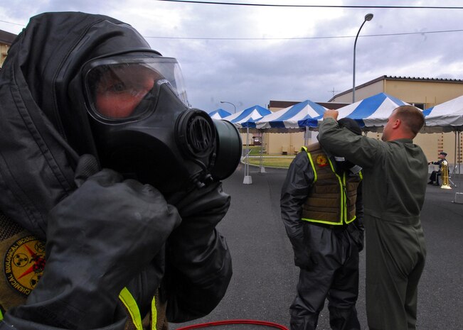 Marines with the Chemical, Biological Incident Response Force, don their Mission Oriented Protective Posture suits prior to a bilateral demonstration at Yokota Air Base, Japan, April 23. The Marines of CBIRF and the Japan Ground Self Defense Forces demonstrated their collective ability to work together in a chemical, biological or nuclear event to Japan's Minister of Defense Toshimi Kitazawa and Air Force Lt. Gen. Burton M. Field, commander of the Joint Support Force and the United States Forces, Japan.::r::::n::::r::::n::::r::::n::