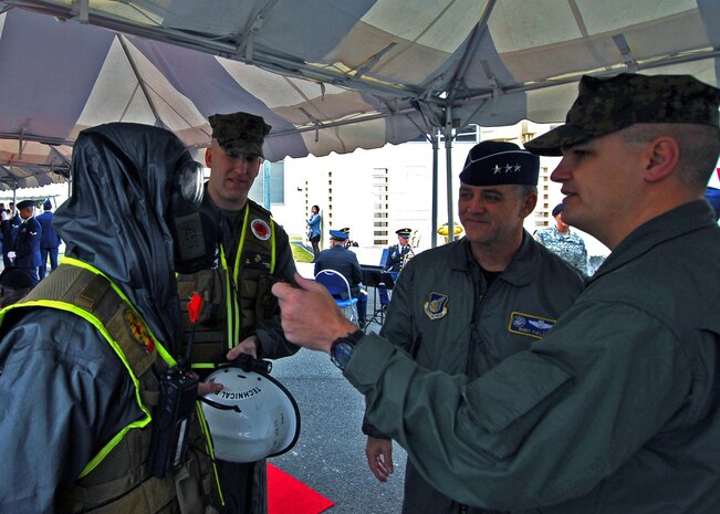 Air Force Lt. Gen. Burton M. Field, commander of the Joint Support Force and the United States Forces, Japan, and Allentown, Pa., native, Marine Corps Maj. Michael Johnson, mission commander of the Chemical, Biological Incident Response Force, inspects a Marine's Mission Oriented Protective Posture suit at Yokota Air Base, Japan, prior to Japan's Minister of Defense Toshimi Kitazawa's arrival, April 23. Kitazawa and Field were on hand to watch the Marines with CBIRF, and the Japan Ground Self Defense Forces demonstrate their collective ability to work together in a chemical, biological or nuclear event.::r::::n::::r::::n::::r::::n::