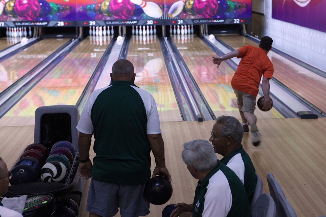 A bowler maneuvers to put a spin on his ball for a strike as others wait for their turn during the 2011 North Carolina State USCBA Open Championship Tournament, April 30.::r::::n::::r::::n::
