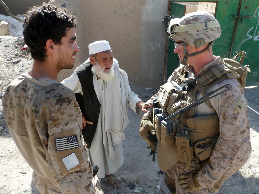 1st Lt. Benjamin J. O’Donnell (right), the platoon commander for 3rd Platoon, Company A, 1st Battalion, 5th Marine Regiment, speaks to a homeowner at his compound in Sangin, Afghanistan, April 30. O’Donnell and the rest of 3rd Platoon develop relationships with the people of Sangin through their overnight patrols. O’Donnell, 26, is from Apalachin, N.Y.