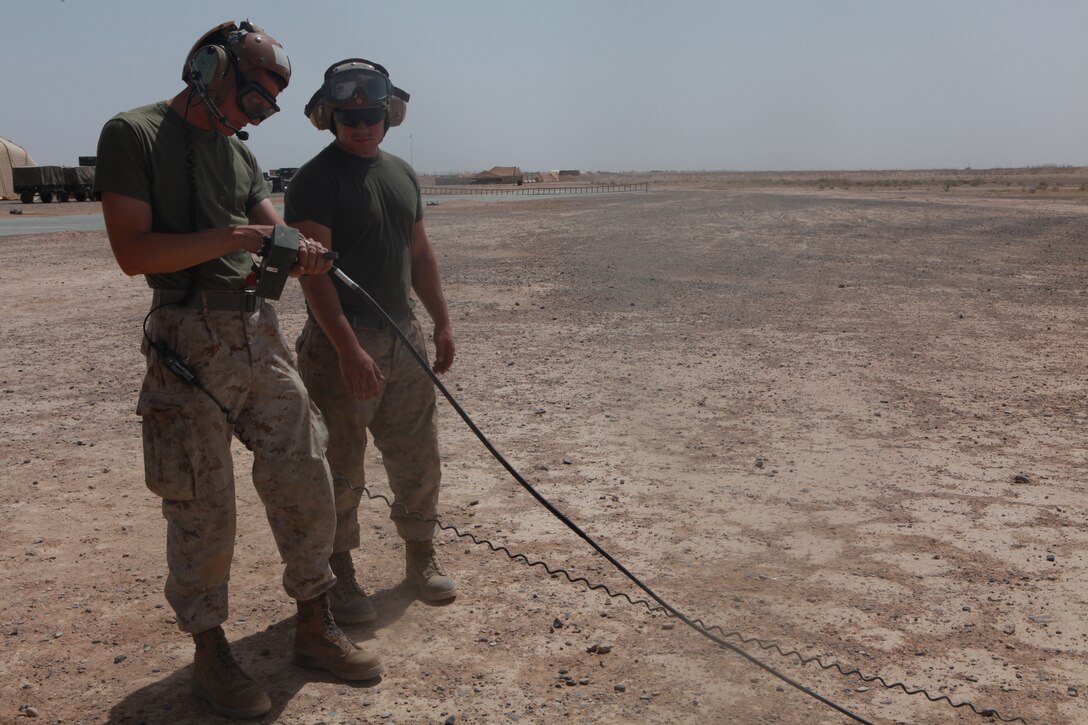 Cpl. Christopher Jones and Lance Cpl. Dustin K. Bergerom, both unmanned aerial vehicle technicians with Marine Unmanned Aerial Vehicle Squadron 3, wait as an RQ-7B Shadow unmanned aerial vehicle prepares for launch from Camp Dwyer, Afghanistan, April 30. Marine Unmanned Aerial Vehicle Squadron 3, deployed out of Twentynine Palms, Calif., took the duties of providing Marine Corps UAV support in Nimroz and Helmand provinces, May 7.