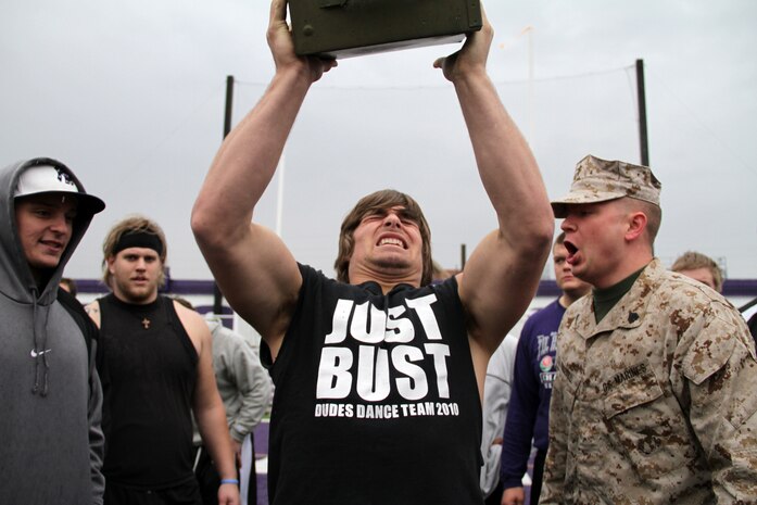 Sgt. Jonathan M. Rueppel, 25, from Yankton, S.D., motivates Winona State Warrior Tyler Kubler, a defensive end and redshirt freshman, during the ammo can lift portion of a modified combat fitness test at Maxwell Field April 30. Kubler, who graduated from Eden Prairie High School, completed 112 ammo can lifts in two minutes. Rueppel is a recruiter out of the Mankato, Minn., office. For more photos of the event, visit www.facebook.com/rstwincities.
