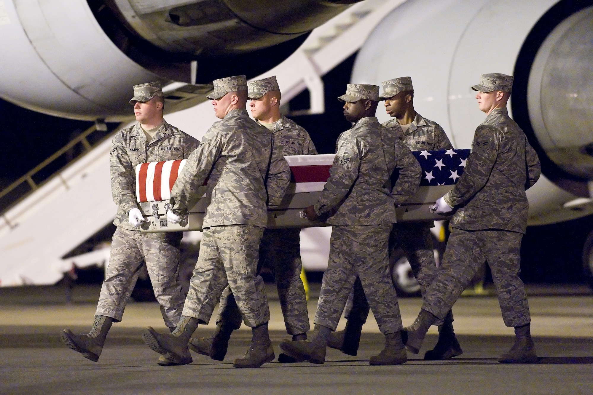 A U.S. Air Force carry team transfers the remains of Air Force Capt. Nathan J. Nylander, of Hockley, Texas, at Dover Air Force Base, Del., April 30, 2011. Nylander was assigned to the 25th Operational Weather Squadron, Davis-Monthan Air Force Base, Ariz. (U.S. Air Force photo/Roland Balik)
