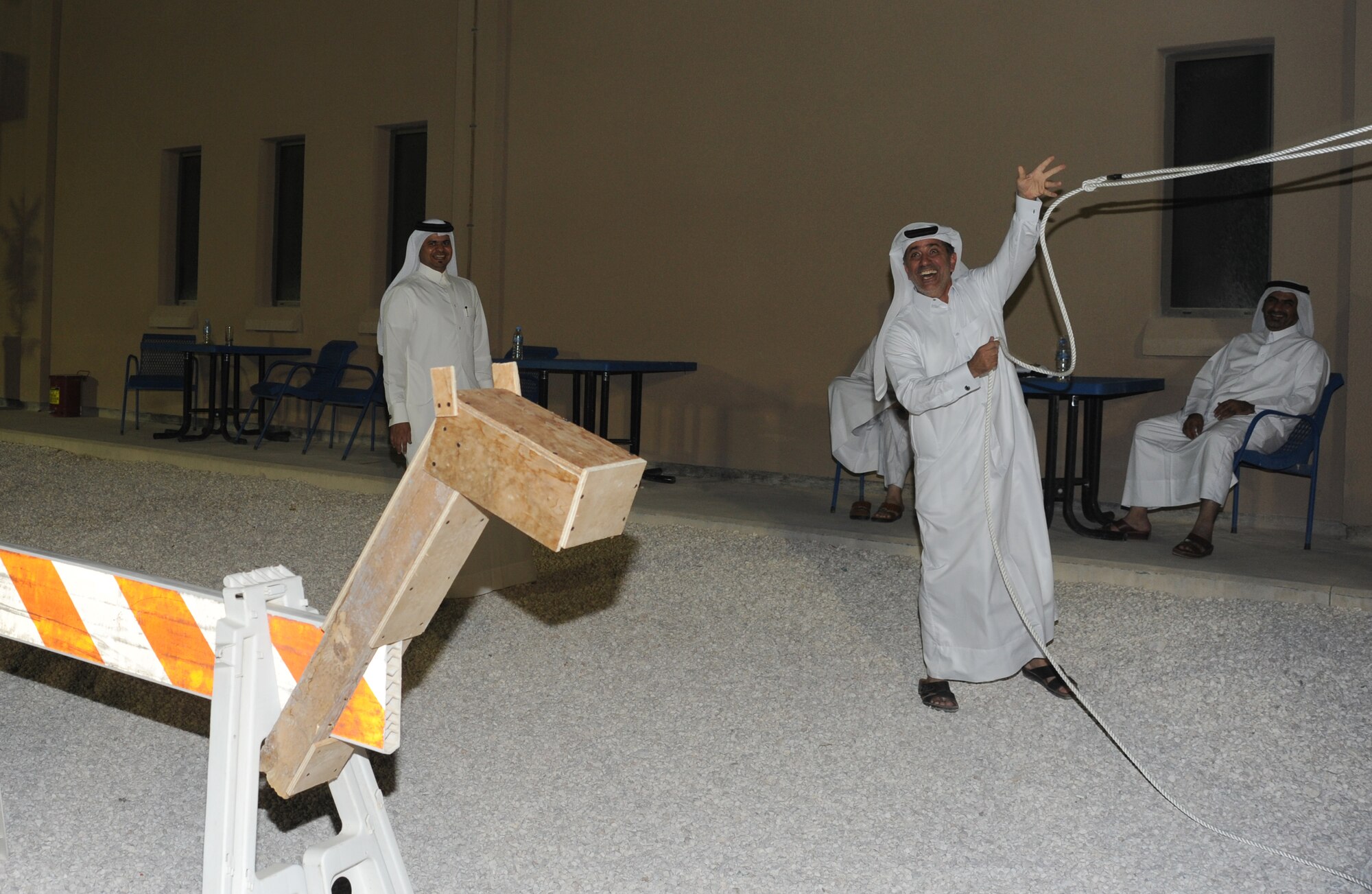 Lt. Col. Mohammed Abdulla Mohd. Saleh, pratices lassoing during at Texas-style barbecue April 27 in Southwest Asia. The event also included various activities such as horseshoes and lassoing, along with a traditional western meal. (U.S. Air Force photo/Staff Sgt. Liliana Moreno)                         