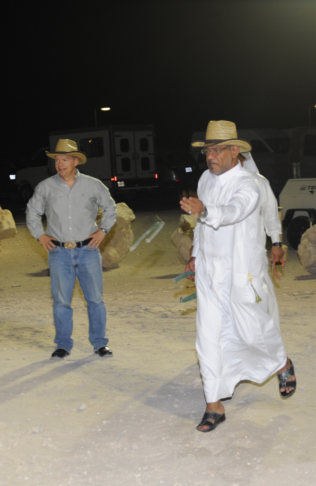 Col. Hamad Abdullah Al-Hussaini, pitches a horseshoe during at Texas-style barbecue April 27 in Southwest Asia. The event also included various activities such as horseshoes and lassoing, along with a traditional western meal. (U.S. Air Force photo/Staff Sgt. Liliana Moreno)                         