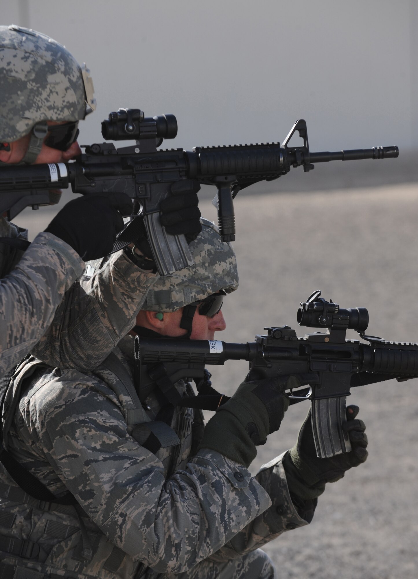 Maj. Damian Schlussel, commander of the 380th Expeditionary Security Forces Squadron, and 1st Lt. Eric Kowalski, 380th ESFS, keep eyes on their target during practice Mar. 4, 2011, in Southwest Asia. Security Forces must remain up to date on all training to prepare them for quick response to any real world situation, anytime. (U.S. Air Force photo by Senior Airman Maynelinne De La Cruz)