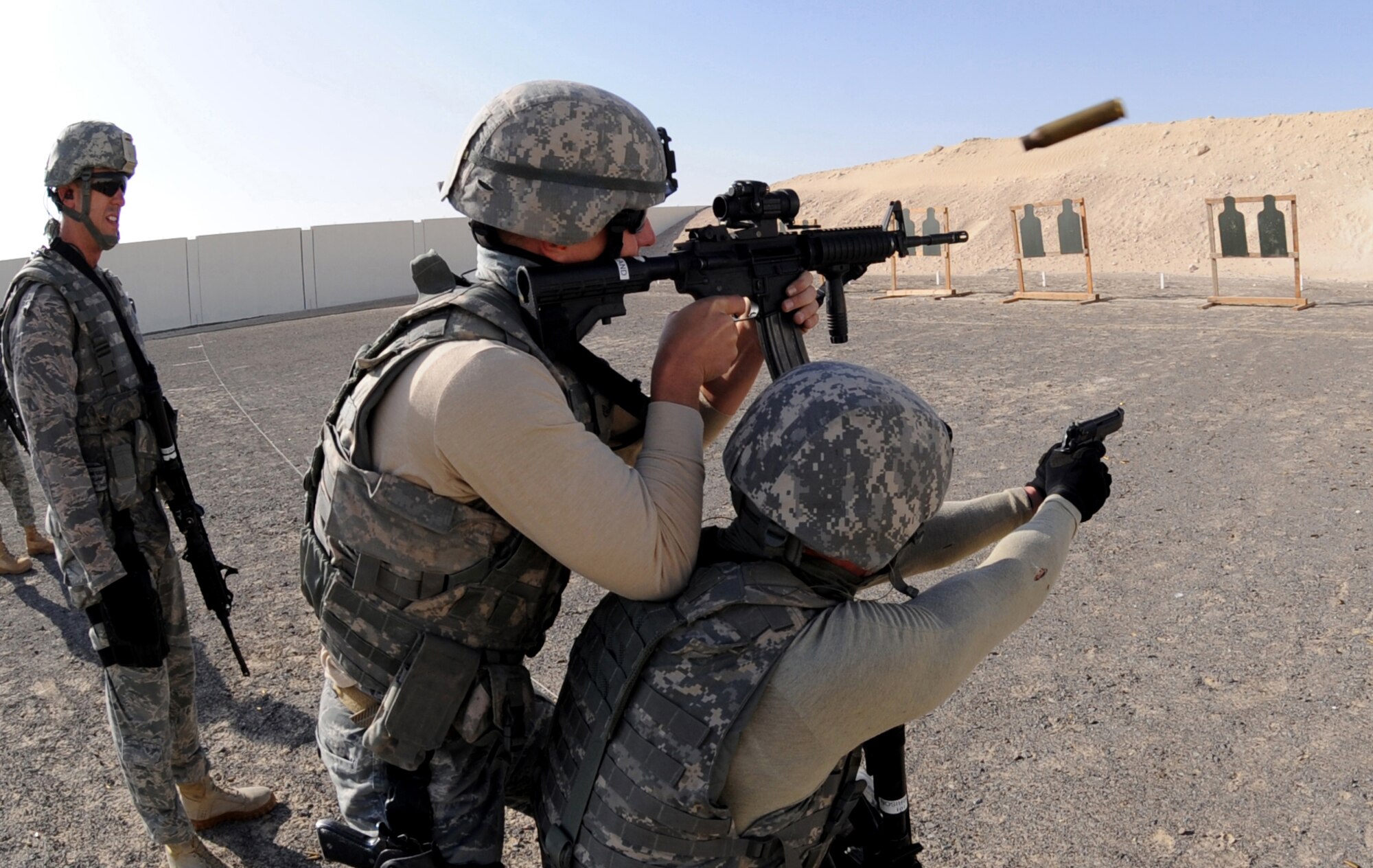 Maj. Damian Schlussel (left), 380th Expeditionary Security Forces Squadron commander evaluates Staff Sgt. Kevin Cleveland (center), 380th ESFS and Staff Sgt. Bryan Morrison (left), 380th ESFS, as they practice tactical maneuvers at the firing range Mar. 4, 2011, in Southwest Asia. Security Forces must remain up to date on all training to prepare them for quick response to any real world situation, anytime. Sergeant Cleveland is deployed from the 627th SFS, McChord AFB, Wash., and Sergeant Morrison is deployed from 628th SFS, Charleston AFB, S.C. (U.S. Air Force photo by Senior Airman Maynelinne De La Cruz)