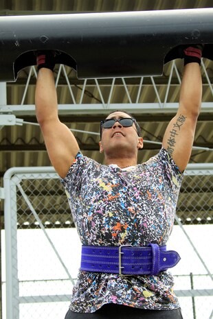 Anthony Saenz, 191-and-over pound men's weight group division competitor, pushes out a repetition during the steal log press during the annual Iwakuni Strongman Competition at the Penny Lake field here April 30. Saenz carried 280 pounds during the farmer's walk across 122 meters, 35 7-ton tire flips, 40.46 seconds on the iron cross, 8 reps during the steel log press, and 29.02 seconds during the Humvee pull.