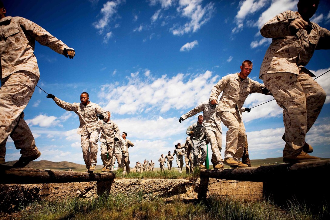 Marines from 1st Battalion, 11th Marine Regiment, 1st Marine Division, I Marine Expeditionary Force out of Camp Pendleton, Calif., race through a confidence course during the field training exercise portion of Exercise Khaan Quest 2011 at Five Hills Training Area near Ulaanbaatar, Mongolia, Aug. 1. Khaan Quest is a training exercise designed to strengthen the capabilities of U.S., Mongolian and other participating nations’ forces in international peace support operations worldwide.