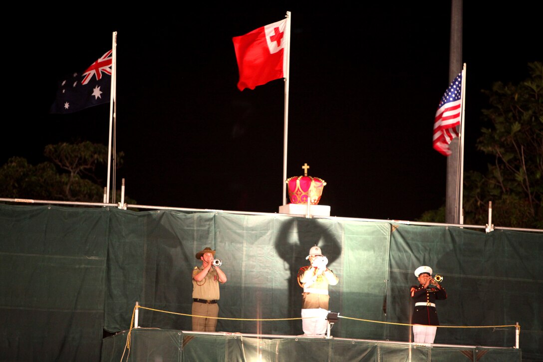 Musicians from the Australian Army Band Kapooka, the Tongan Royal Corps of Musicians and the U.S. Marine Corps Forces, Pacific, Band from Hawaii play their bugles during the closing ceremony of the Kingdom of Tonga Military Parade and Tattoo, Aug. 2. A Tattoo is comprised of military units – musical and operational – from different countries collaborating in an extensive exhibition of musical performances and demonstrating military capabilities.