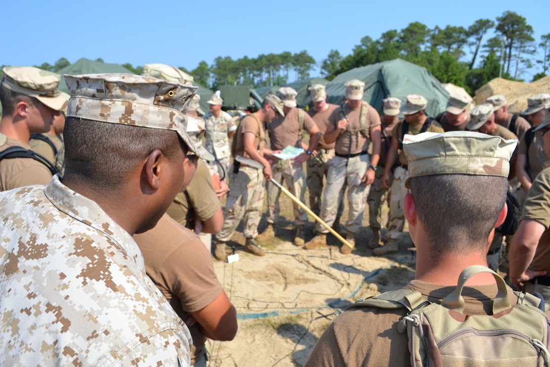 A 2nd LAAD Marine oversees Port Security Unit 301’s training as they build a terrain model for planning defenses aboard MCAS Cherry Point, Aug. 1. One of Port Security Unit 301’s mission is to combat terrorist threats against maritime military assets. To perfect their skills, 2nd LAAD Marines shared their experience with PSU 301 during training operations from July 31 – Aug. 9.