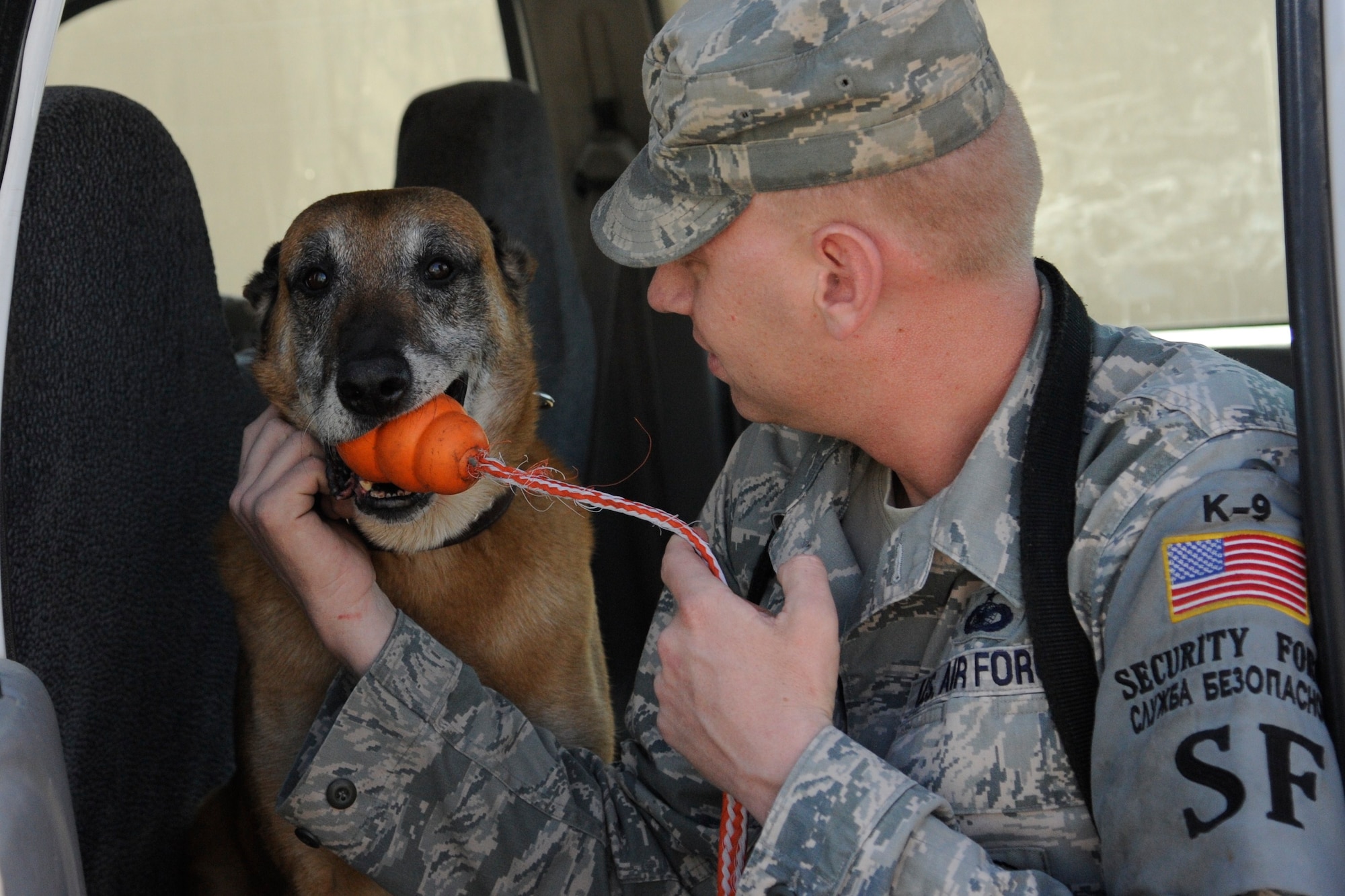 Staff Sgt. Christopher Fall and Lucky relax after completing a proficiency training session at the Transit Center at Manas, Kyrgyzstan, July 28. Lucky, a Belgian Malinois, is the oldest military working dog at the Transit Center. He is 10-years old. Fall is a 376th Expeditionary Security Forces Squadron military working dog handler. Lucky and Fall are deployed here from Fairchild Air Force Base, Wash. (U.S. Air Force photo/Tech. Sgt. Tammie Moore)