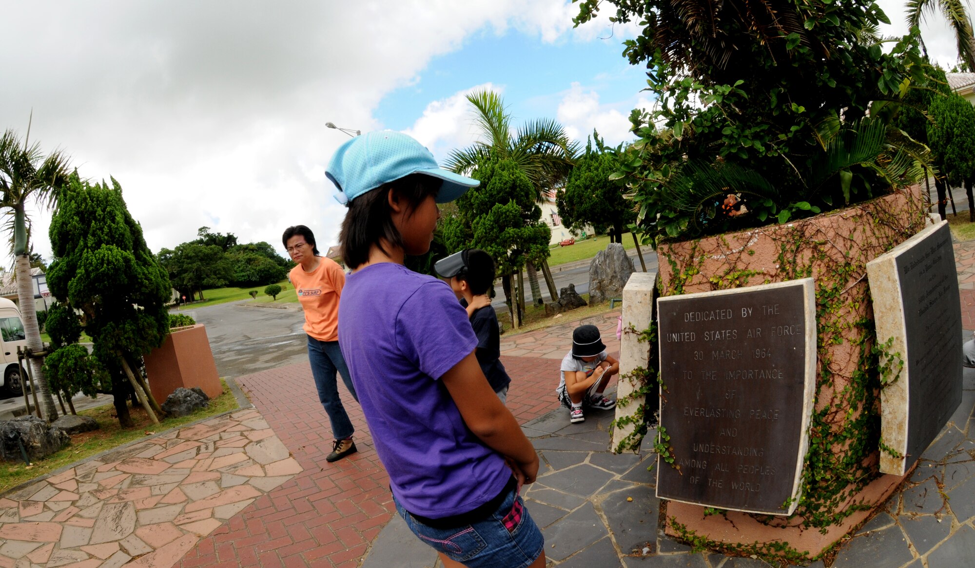 Shiho Tamanaha, a student from Misato, Okinawa City, looks at a dedication plaque during the Kodomo-Kai children's group visit to World War II historical sites July 29, Kadena Air Base, Japan. The group partake in an annual peace education event organized by Misato Residents' Association during the summer vacation. (U.S. Air Force photo/Airman 1st Class Jarvie Z. Wallace)
