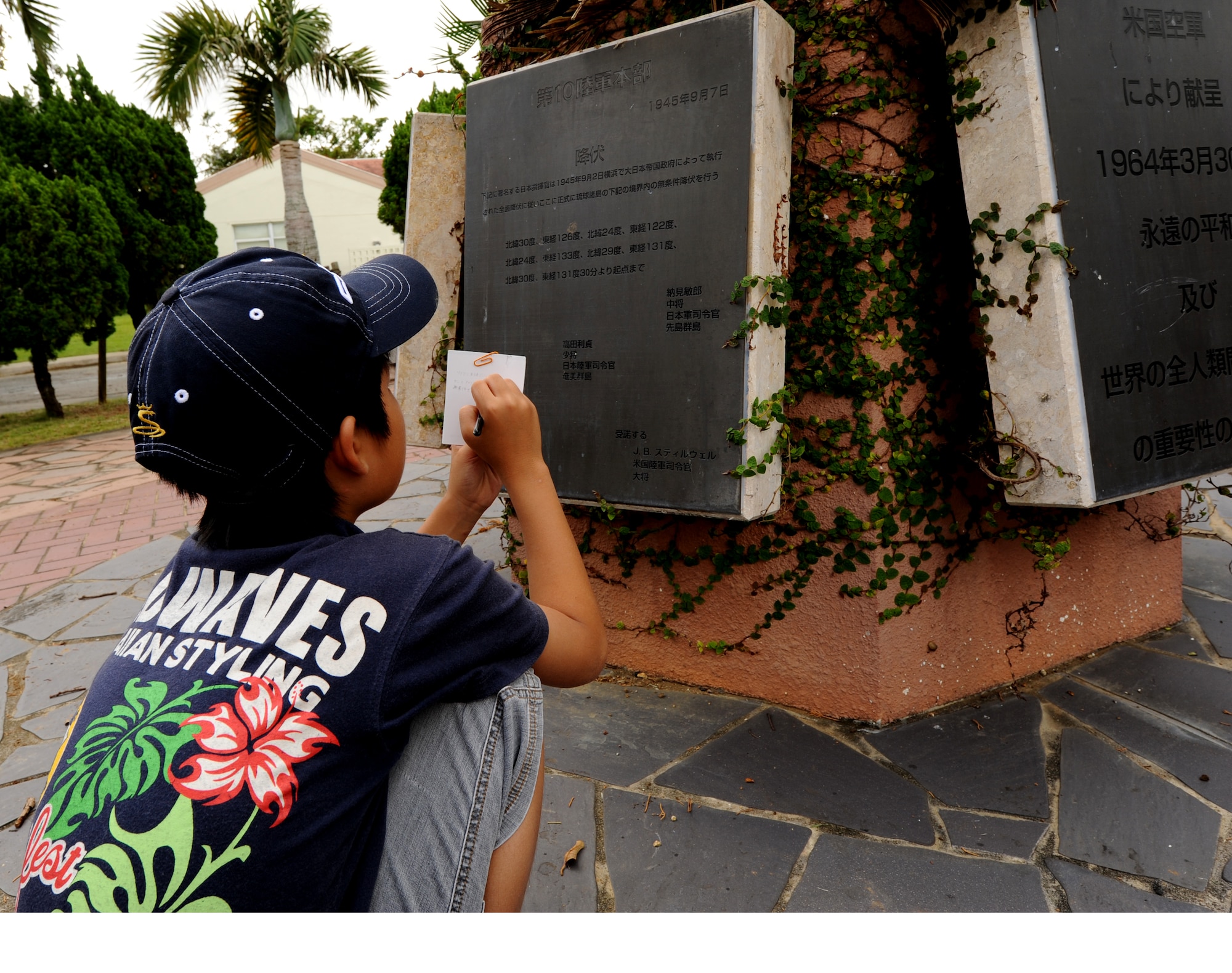Keita Tamanaha, a student from Misato, Okinawa City, takes notes during the Kodomo-Kai children's group visit toWorld War II historical sites July 29, Kadena Air Base, Japan. The group partake in an annual peace education event organized by Misato Residents' Association during the summer vacation (U.S. Air Force photo/Airman 1st Class Jarvie Z. Wallace)