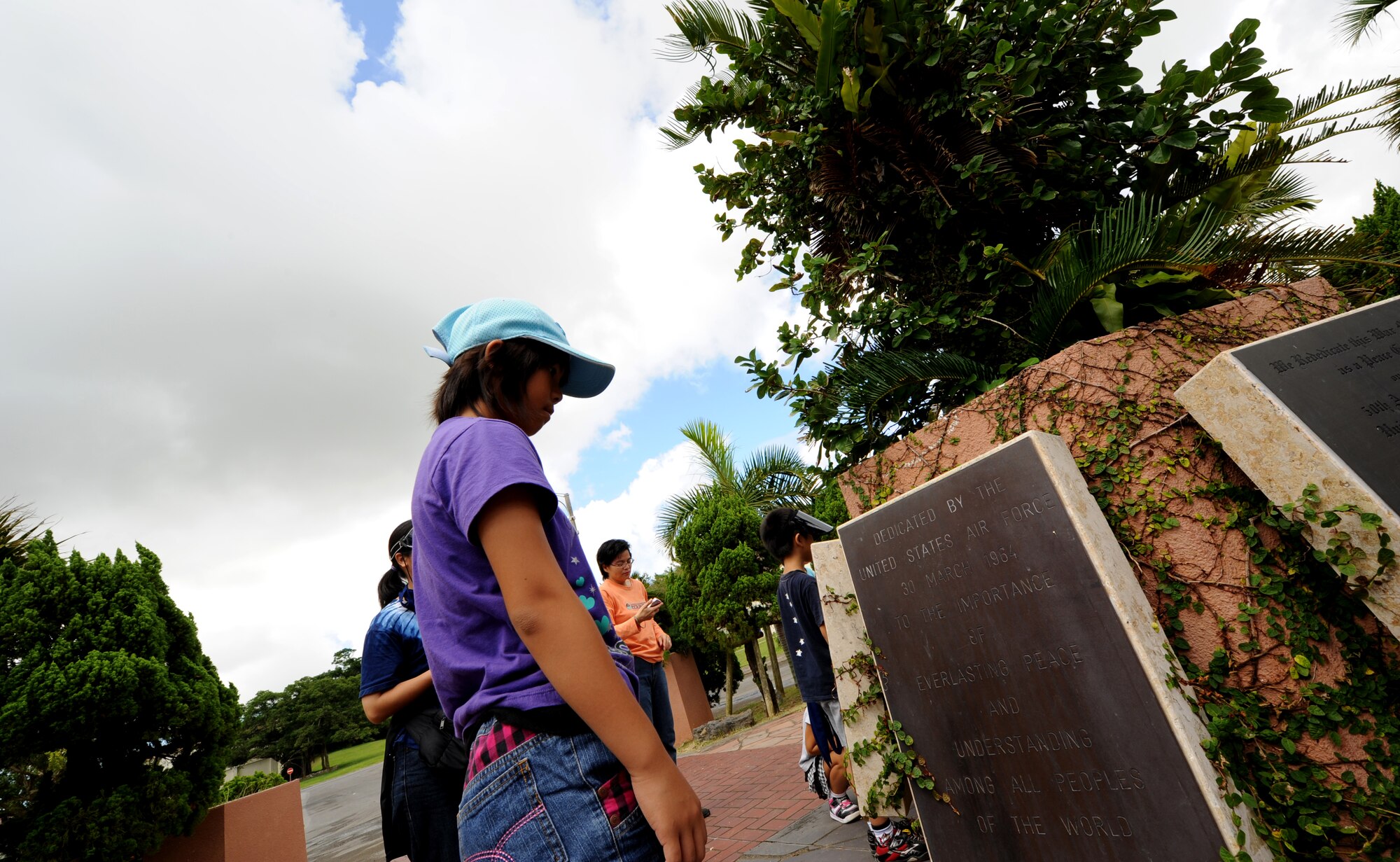 Shiho Tamanaha, a student from Misato, Okinawa City, looks at a dedication plaque during the Kodomo-Kai children's group visit toWorld War II historical sites July 29, Kadena Air Base, Japan. The group partake in an annual peace education event organized by Misato Residents' Association during the summer vacation. (U.S. Air Force photo/Airman 1st Class Jarvie Z. Wallace)