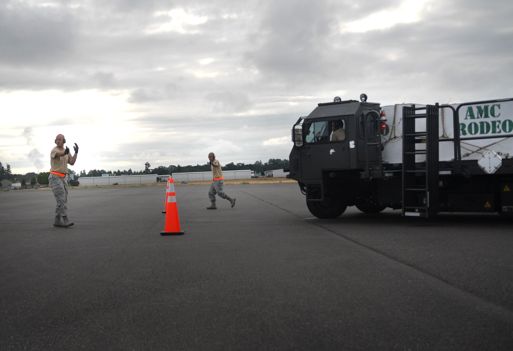 Tech. Sgt. Michael Heifner and Staff Sgt. Reynaldo Penamora guide Staff Sgt. Cory Tomlinson through an obstacle course on the flight line at Joint Base Lewis-McChord, Wash., during Air Mobility Rodeo 2011. Heifner and Tomlinson are aerial porters assigned to the 730th Air Mobility Squadron at Yokota Air Base, Japan, and Penamora is part of the 735th Air Mobility Squadron at Joint Base Pearl Harbor-Hickam, Hawaii. All three units are part of the 515th Air Mobility Operations Wing, a geographically-separated unit comprised of six squadrons throughout the Pacific. It is headquartered at JBPHH. (U.S. Air Force photo/Staff Sgt. Carolyn Herrick)