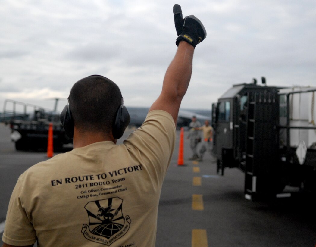Senior Airman Jeremy Jweinat, a 734th Air Mobility Squadron aerial porter from Andersen Air Force Base, Guam, guides a 25k Halvorsen loader through an obstacle course on the flight line at Joint Base Lewis-McChord, Wash., during Air Mobility Rodeo 2011. The 734th AMS is part of the 515th Air Mobility Operations Wing, a geographically-separated unit comprised of six squadrons throughout the Pacific. It is headquartered at Joint Base Pearl Harbor-Hickam, Hawaii. (U.S. Air Force photo/Staff Sgt. Carolyn Herrick)