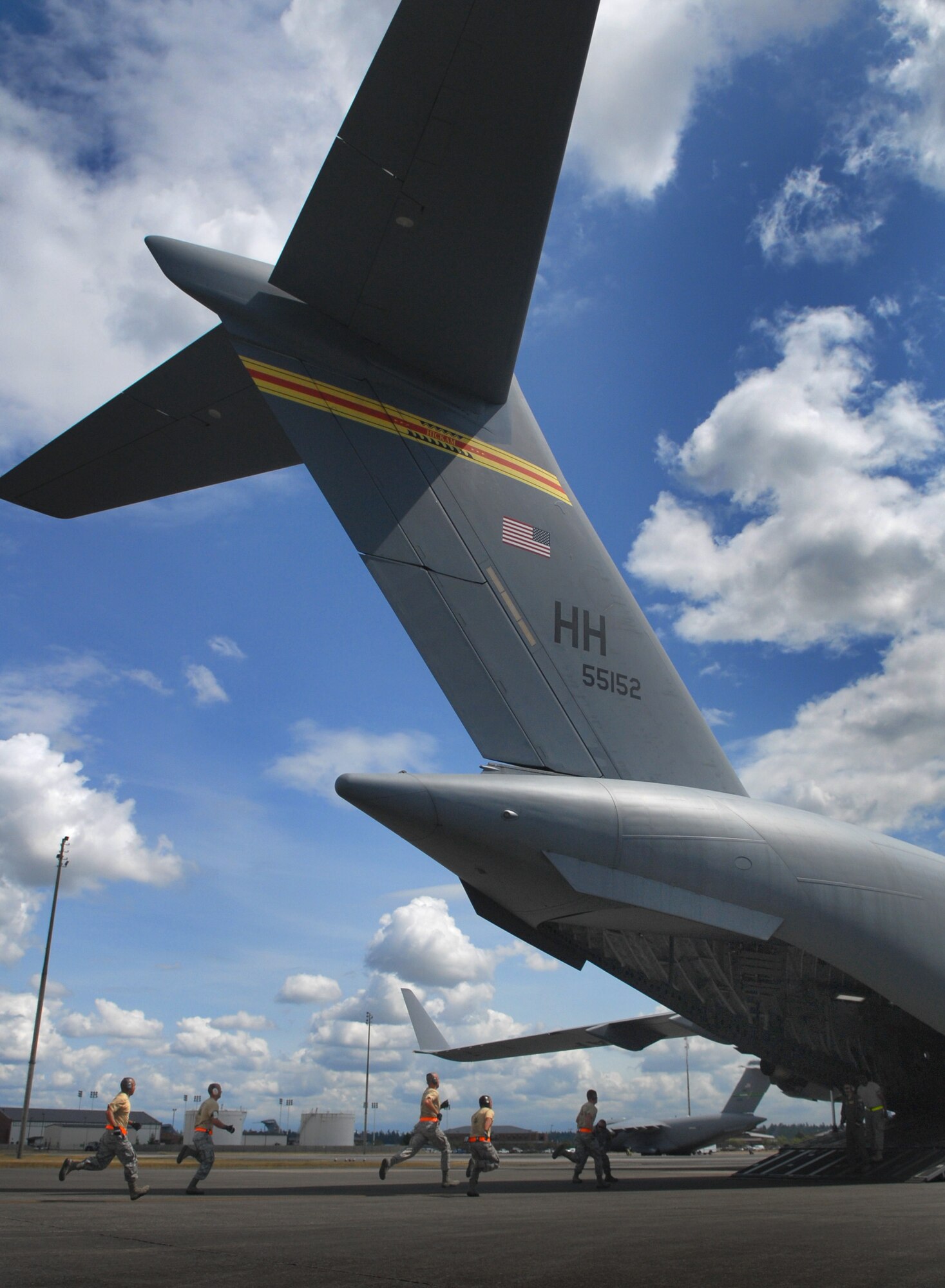 Aerial Port Airmen from Joint Base Pearl Harbor-Hickam, Hawaii, perform an engine-running on-load and off-load on C-17 Globemaster III during Air Mobility Rodeo 2011 at Joint Base Lewis-McChord, Wash., July 27. Air Mobility Rodeo is the U.S. Air Force's and Air Mobility Command's premier international combat skill and flying operations competition designed to develop and improve techniques, procedures and interoperability, while optimizing international mobility partnerships and enhancing mobility operations. (U.S. Air Force photo/Staff Sgt. Carolyn Herrick)