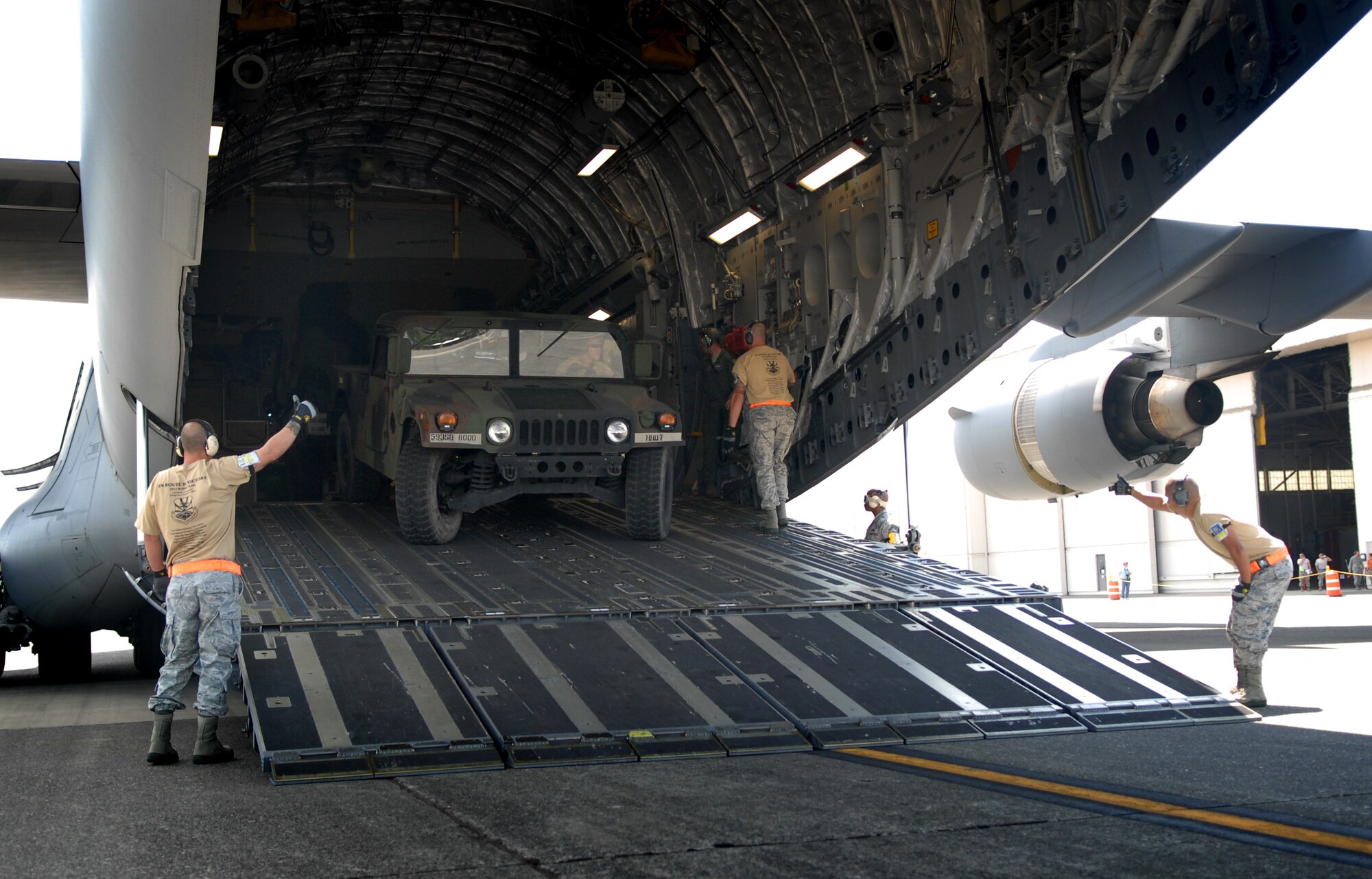 Aerial Port Airmen from Joint Base Pearl Harbor-Hickam, Hawaii, perform an engine-running on-load and off-load on C-17 Globemaster III during Air Mobility Rodeo 2011 at Joint Base Lewis-McChord, Wash., July 27. Air Mobility Rodeo is the U.S. Air Force's and Air Mobility Command's premier international combat skill and flying operations competition designed to develop and improve techniques, procedures and interoperability, while optimizing international mobility partnerships and enhancing mobility operations. (U.S. Air Force photo/Staff Sgt. Carolyn Herrick)