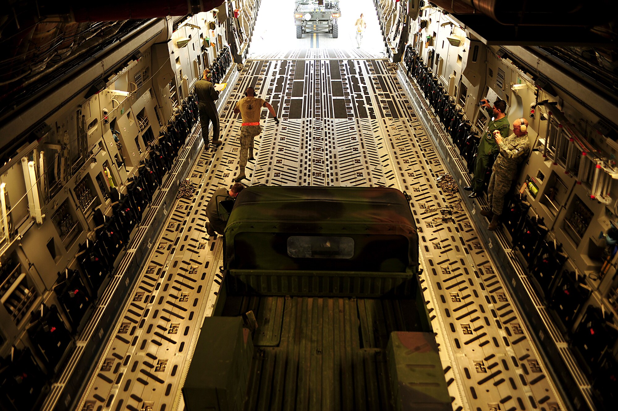 Aerial Port Airmen from Joint Base Pearl Harbor-Hickam, Hawaii, perform an engine-running on-load and off-load on C-17 Globemaster III during Air Mobility Rodeo 2011 at Joint Base Lewis-McChord, Wash., July 27. Air Mobility Rodeo is the U.S. Air Force's and Air Mobility Command's premier international combat skill and flying operations competition designed to develop and improve techniques, procedures and interoperability, while optimizing international mobility partnerships and enhancing mobility operations. (U.S. Air Force photo/Staff Sgt. Nicholas Pilch)