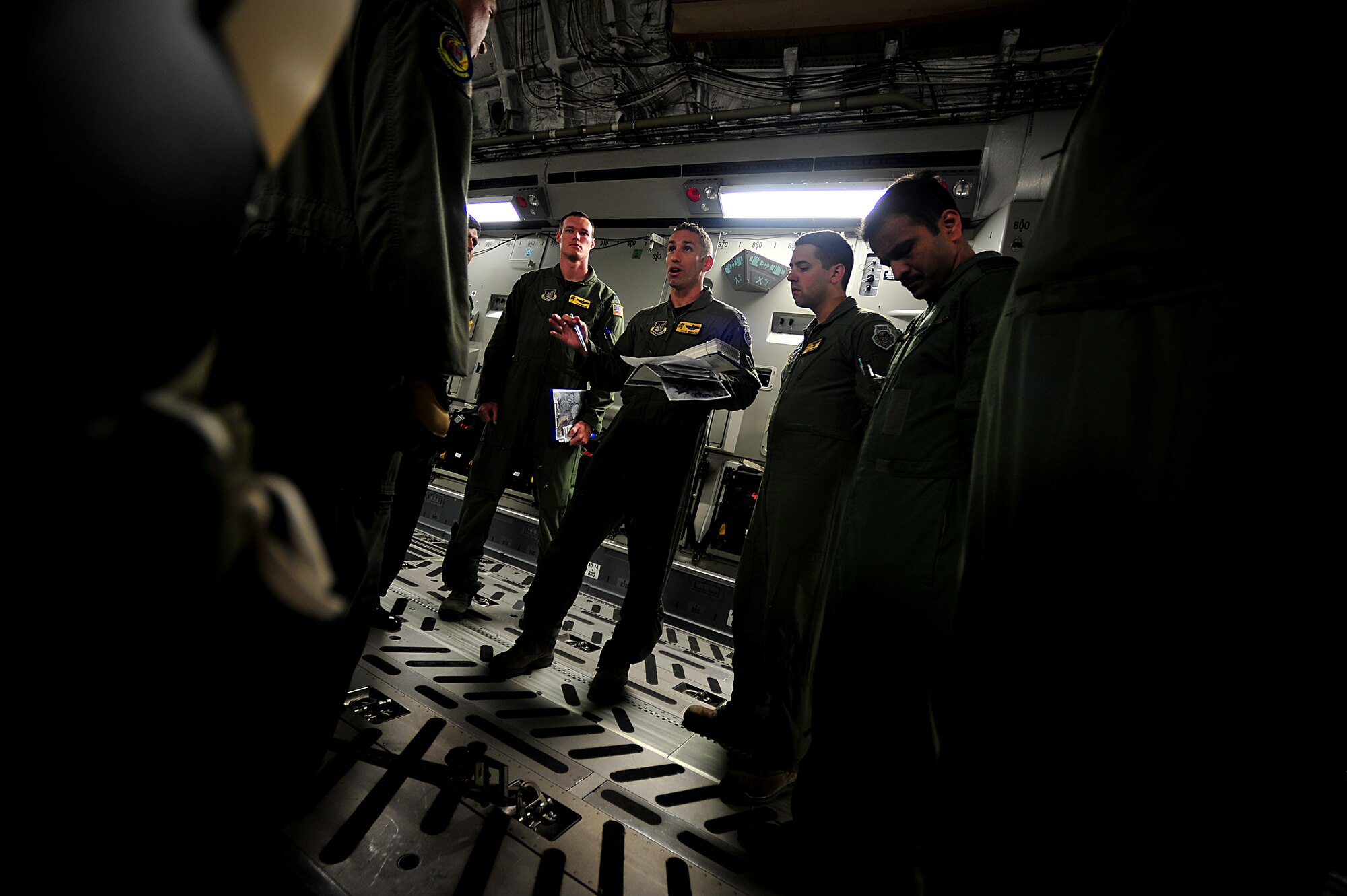 Crew members from Joint Base Pearl Harbor-Hickam, Hawaii, receive a pre-flight briefing during Air Mobility Rodeo 2011 at Joint Base Lewis-McChord, Wash., July 27. Air Mobility Rodeo is the U.S. Air Force's and Air Mobility Commandís premier international combat skill and flying operations competition designed to develop and improve techniques, procedures and interoperability, while optimizing international mobility partnerships and enhancing mobility operations. (U.S. Air Force photo/Staff Sgt. Nicholas Pilch)