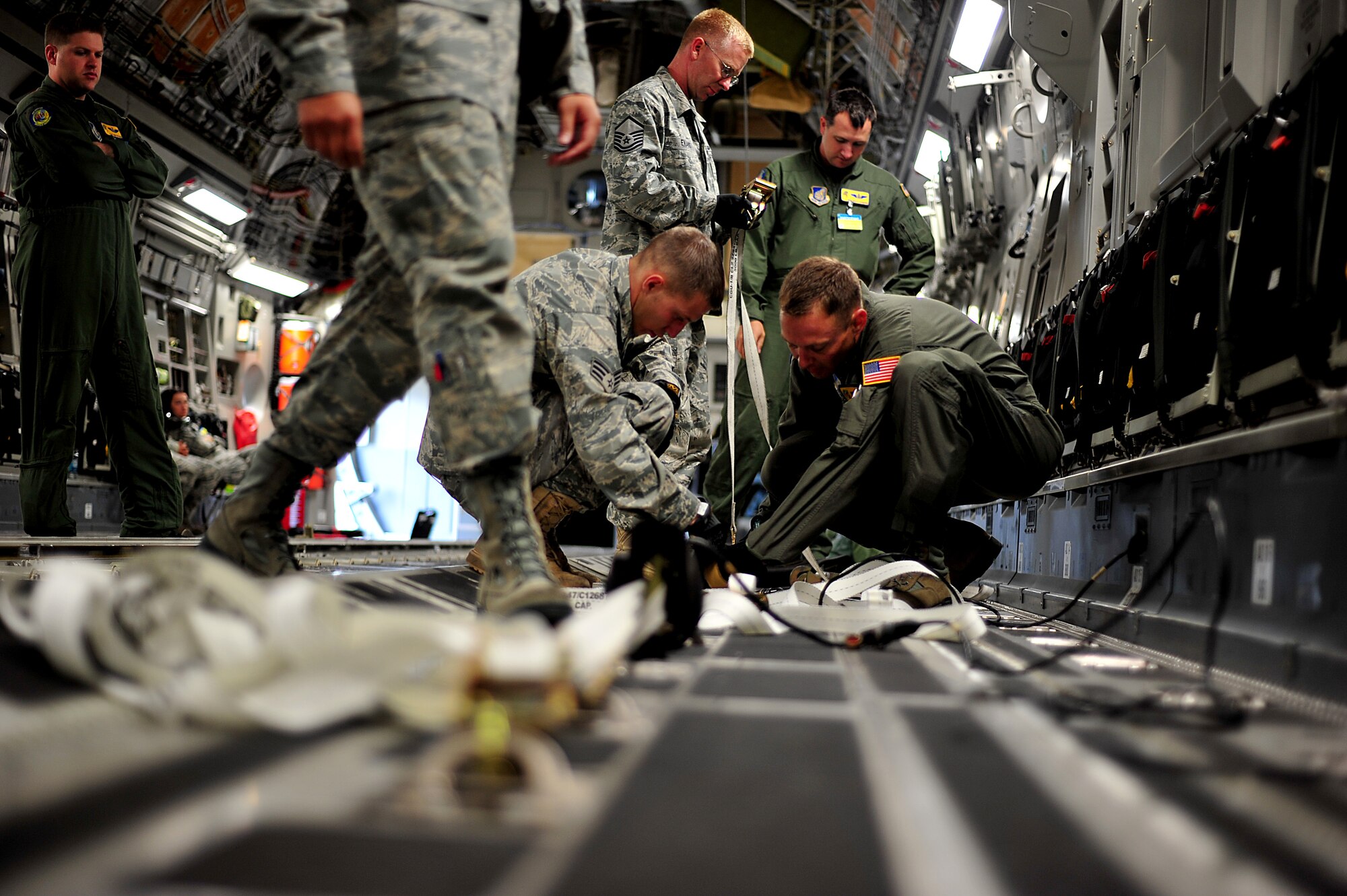 Crew members from Team Hickam prepare a C-17 Globemaster III before a contest at Air Mobility Rodeo 2011 at Joint Base Lewis-McChord, Wash., July 27. Air Mobility Rodeo is the U.S. Air Force's and Air Mobility Command's premier international combat skill and flying operations competition designed to develop and improve techniques, procedures and interoperability, while optimizing international mobility partnerships and enhancing mobility operations. (U.S. Air Force photo/Staff Sgt. Nicholas Pilch)