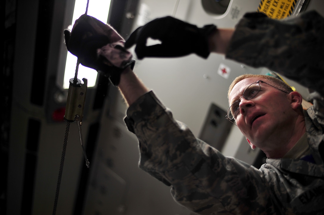 Master Sgt. Mike Evans, a crew chief from Joint Base Pearl Harbor-Hickam, Hawaii, prepares a C-17 Globemaster III before a contest at Air Mobility Rodeo 2011 at Joint Base Lewis-McChord, Wash., July 27. Air Mobility Rodeo is the U.S. Air Force's and Air Mobility Command's premier international combat skill and flying operations competition designed to develop and improve techniques, procedures and interoperability, while optimizing international mobility partnerships and enhancing mobility operations. (U.S. Air Force photo/Staff Sgt. Nicholas Pilch) 