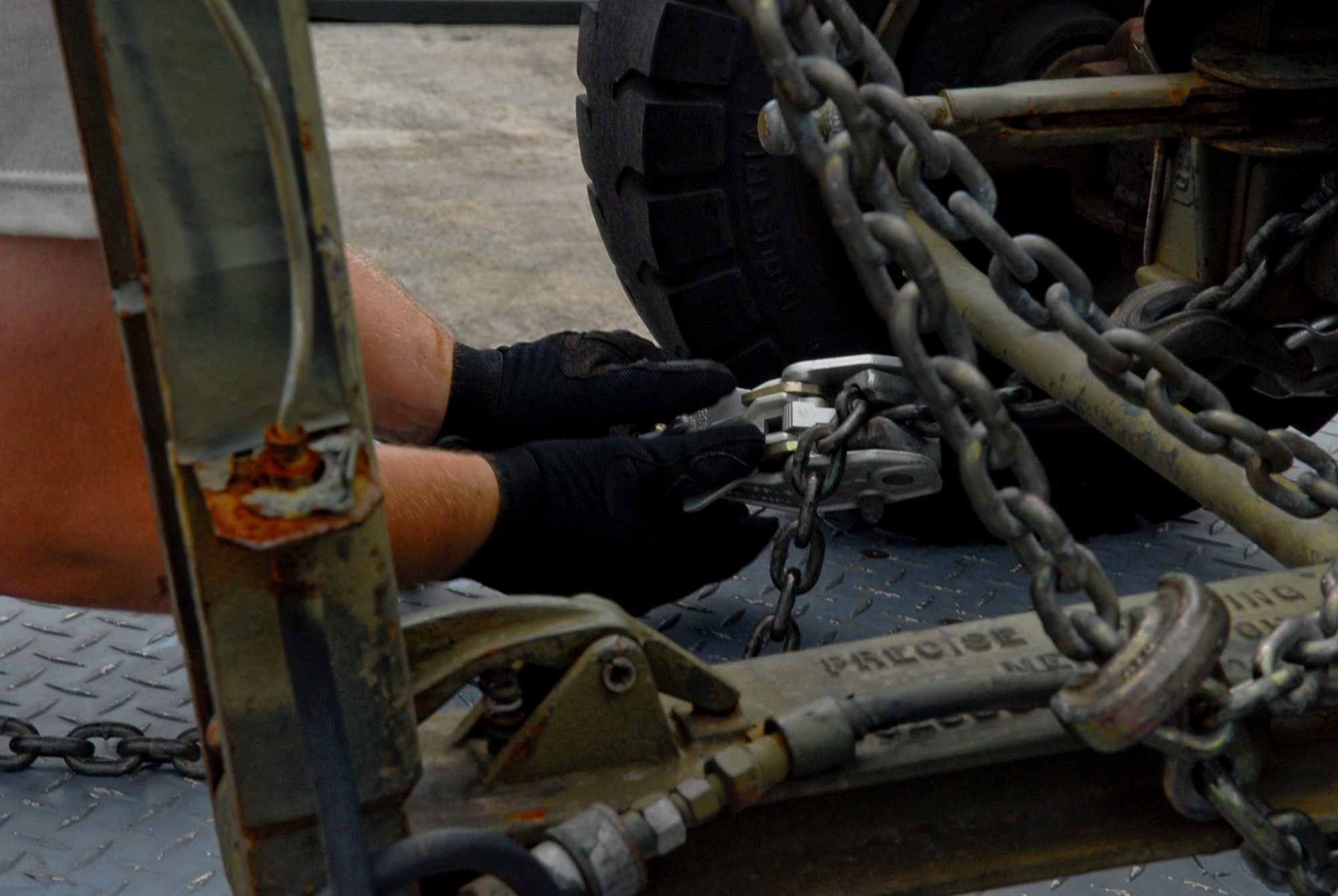Staff Sgt. David Logue, 18th Munitions Squadron equipment maintenance crew chief, secures one of Kadena Air Base's munitions trailers for later use July 26. The trailers are designed for everyday operations and to fulfill the base's overall mission. (U.S. Air Force photo/ Airman 1st Class Tara A. Williamson)