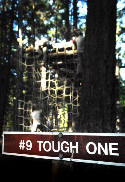 647th Security Forces Squadron Airmen climb obstacle #9, "The Tough One," during the 2011 Air Mobility Rodeo at Joint Base Lewis-McChord, Wash., July 28. They are stationed at Joint Base Pearl Harbor-Hickam, Hawaii. (U.S. Air Force photo by Staff Sgt. Carolyn Herrick)