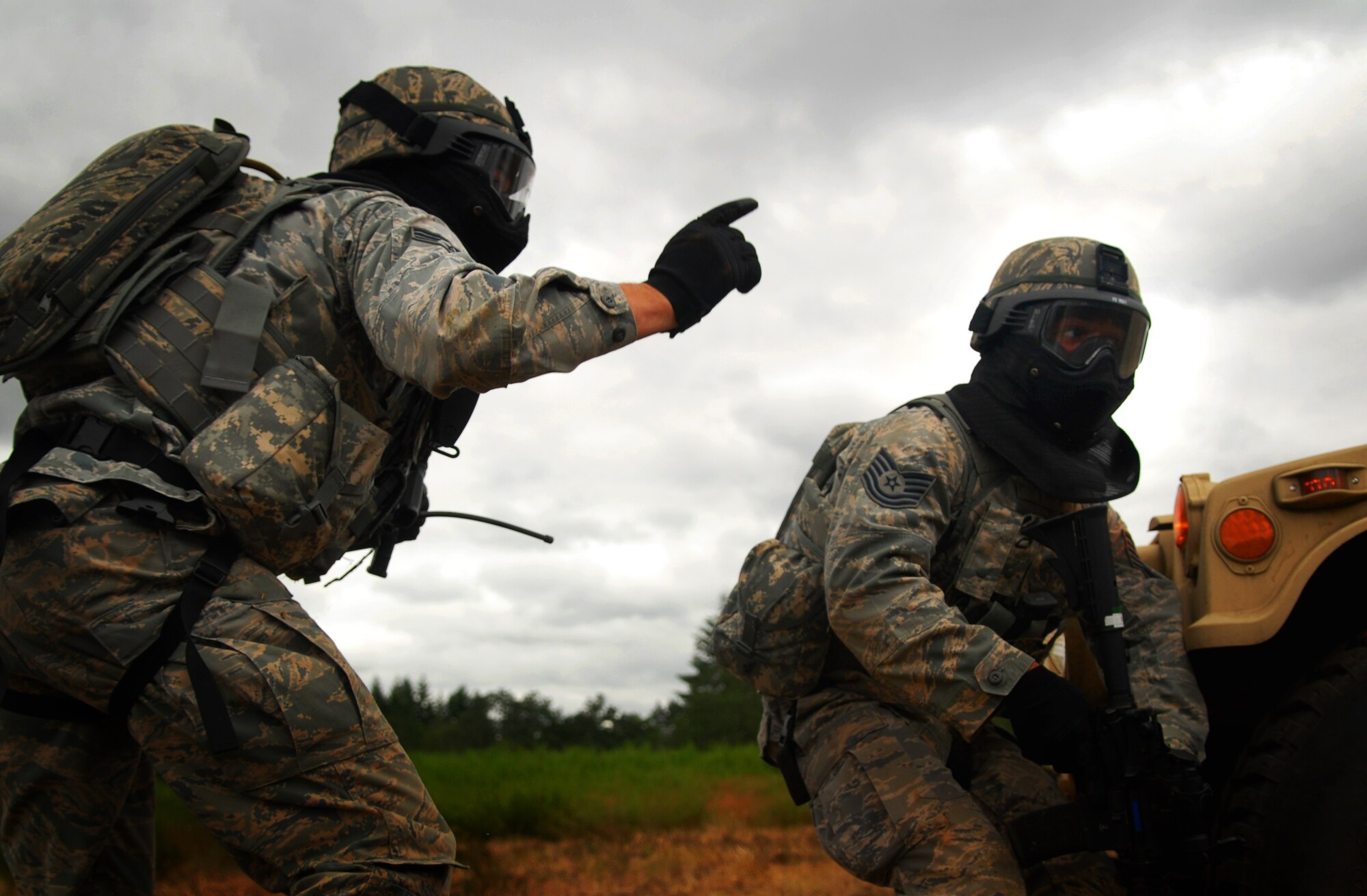 Senior Airman Jeffrey Kristek and Tech. Sgt. Pablo Gonzalez, 647th Security Forces Squadron, respond to incoming fire during a combat tactics event at the 2011 Air Mobility Rodeo at Joint Base Lewis-McChord, Wash., July 26. Kristek is stationed at Joint Base Pearl Harbor-Hickam, Hawaii. (U.S. Air Force photo by Staff Sgt. Carolyn Herrick)