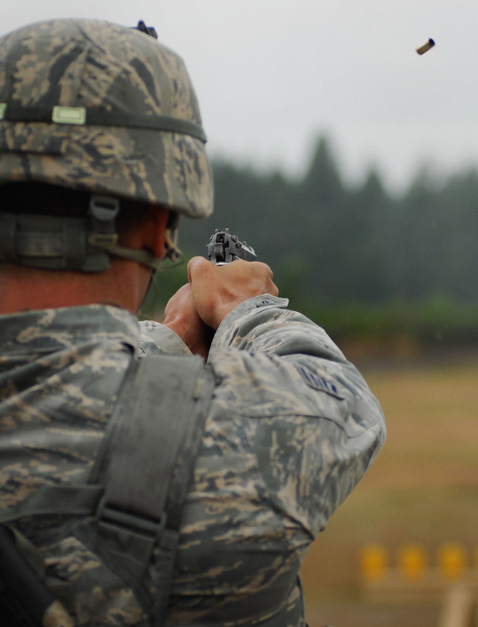 Tech. Sgt. Michael Skonetski, 647th Security Forces Squadron, fires an M-9 during the 2011 Air Mobility Rodeo at Joint Base Lewis-McChord, Wash., July 25. Skonetski is stationed at Joint Base Pearl Harbor-Hickam, Hawaii. (U.S. Air Force photo by Staff Sgt. Carolyn Herrick)