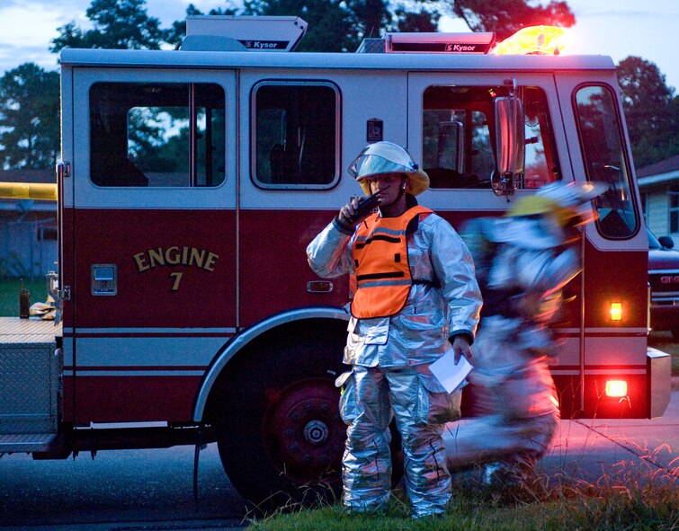 Firefighters with the 2nd Civil Engineer Squadron respond to a simulated fire on Barksdale Air Force Base, La., July 28. The training was held in the unoccupied Capehart housing area which is scheduled for demolition later this year. (U.S. Air Force photo/Senior Airman Chad Warren)(RELEASED)