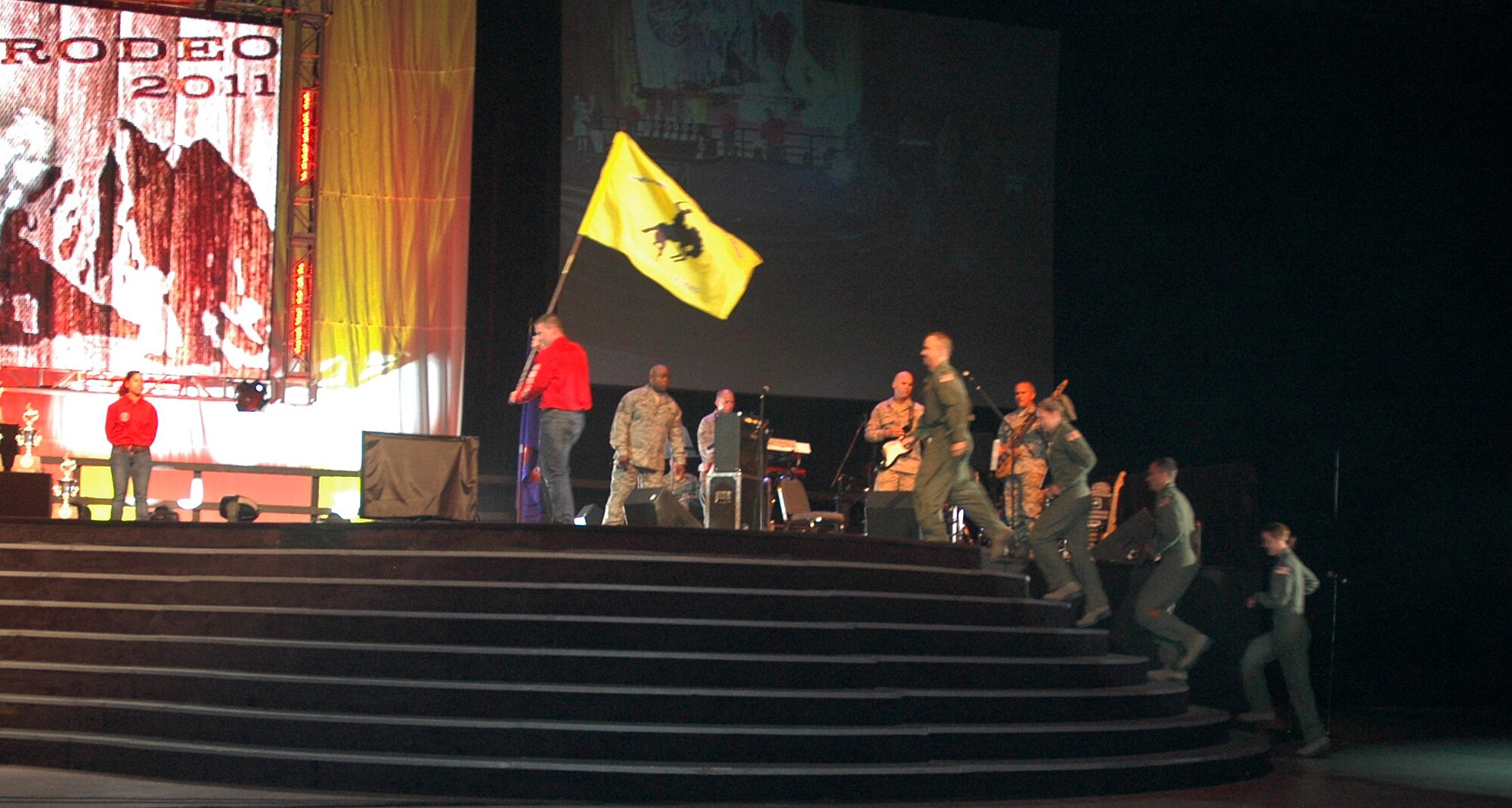 The 446th Airlift Wing's Rodeo aeromedical team runs up on stage July 29 to receive their trophy as Best C-17 Aeromedical Team for Air Mobility Rodeo 2011 at McChord Field, Wash.  Team members are Capt. Jason Cross, Senior Airman Krystal Reinstadler, Senior Airman Dylan Congrove, 2nd Lt. Catherine Carroll  and (not pictured) Senior Airman Marcello Yamaguchi.  (U.S. Air Force photo by Sandra Pishner)