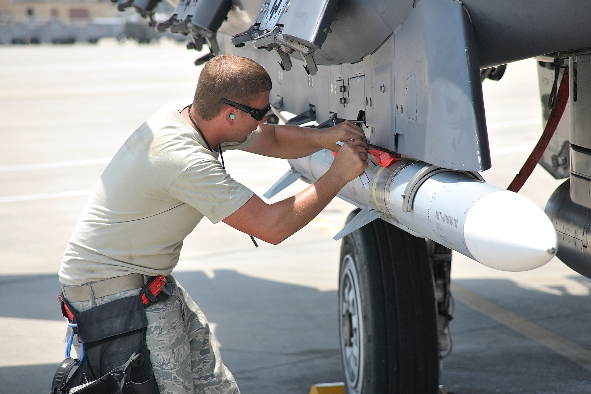 TYNDALL AIR FORCE BASE, Fla. - Staff Sgt. Travis Hass, 389th weapons load crew team chief, attaches a missile to an F-15E Strike Eagle during Combat Archer July 8 to 22 at Tyndall AFB, Fla. Combat Archer is a chance for aircrews to test the total air-to-air weapon system capabilities of the F-15E Strike Eagle. The missions are performed against both sub-scale and full-scale aerial drones that present variety of realistic threats during each evaluation mission. (U.S. Air Force photo by Tech. Sgt. John Hoffmann)