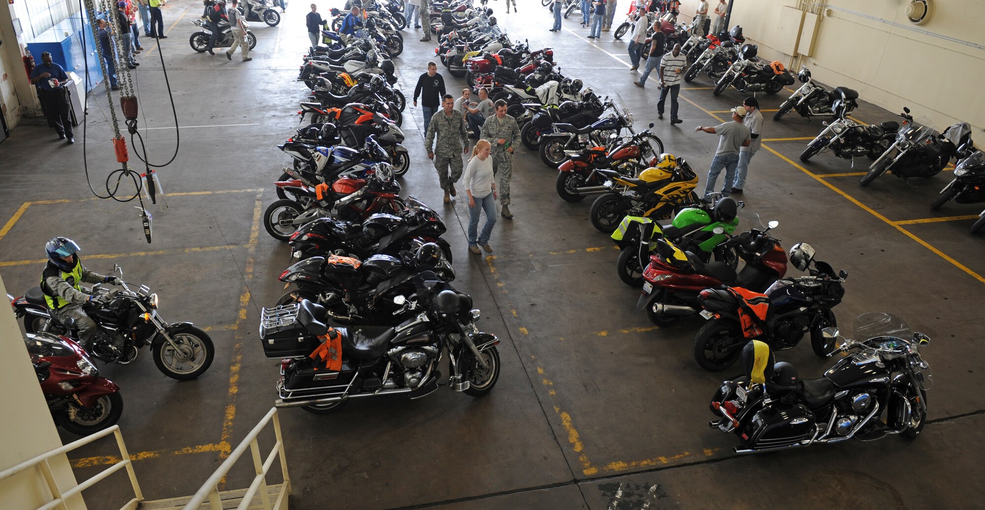 Participants of the Motorcycle Awareness and Remembrance Ride observe the different types of bikes while enjoying refreshments in a hangar on Barksdale Air Force Base, La., July 29. More than 130 riders particiapted in Barksdale's first ever motorcycle safety awareness ride. The event was hosted by the 2nd Bomb Wing Safety office. (U.S.  Air Force photo/Airman 1st Class Micaiah Anthony)(RELEASED)