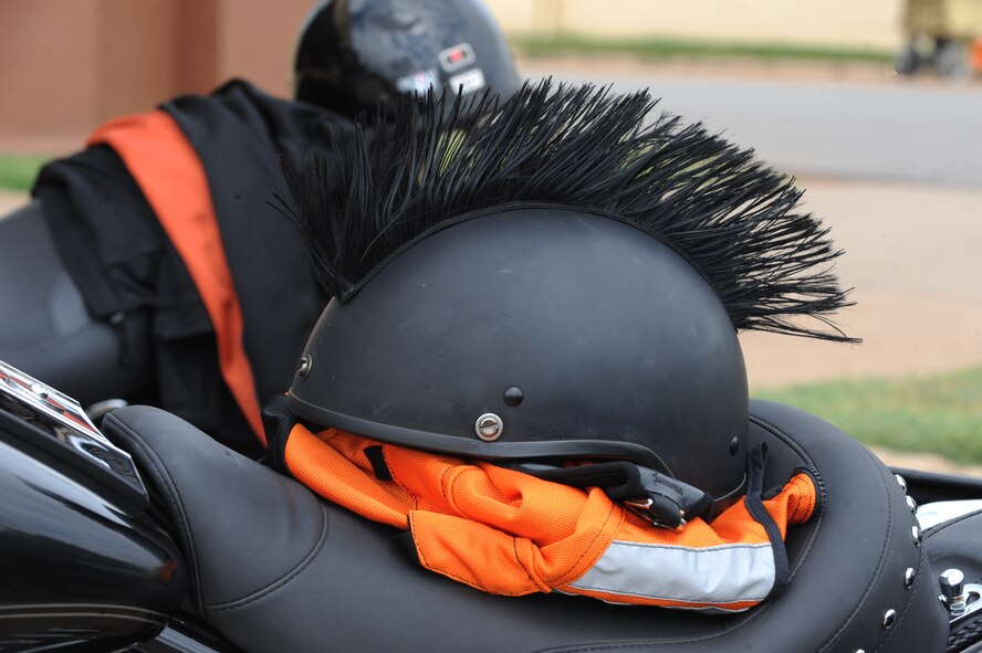 A helmet rests on a motorcycle seat on Barksdale Air Force Base, La., July 29. All active-duty riders and passengers must wear Department of Transportation or Snell approved helmets, full-fingered gloves, brightly colored backpacks, wrap-around eye wear and a reflective vest or brightly colored long-sleeve outer garment while riding on or off base. (U.S.  Air Force photo/Airman 1st Class Micaiah Anthony)(RELEASED)