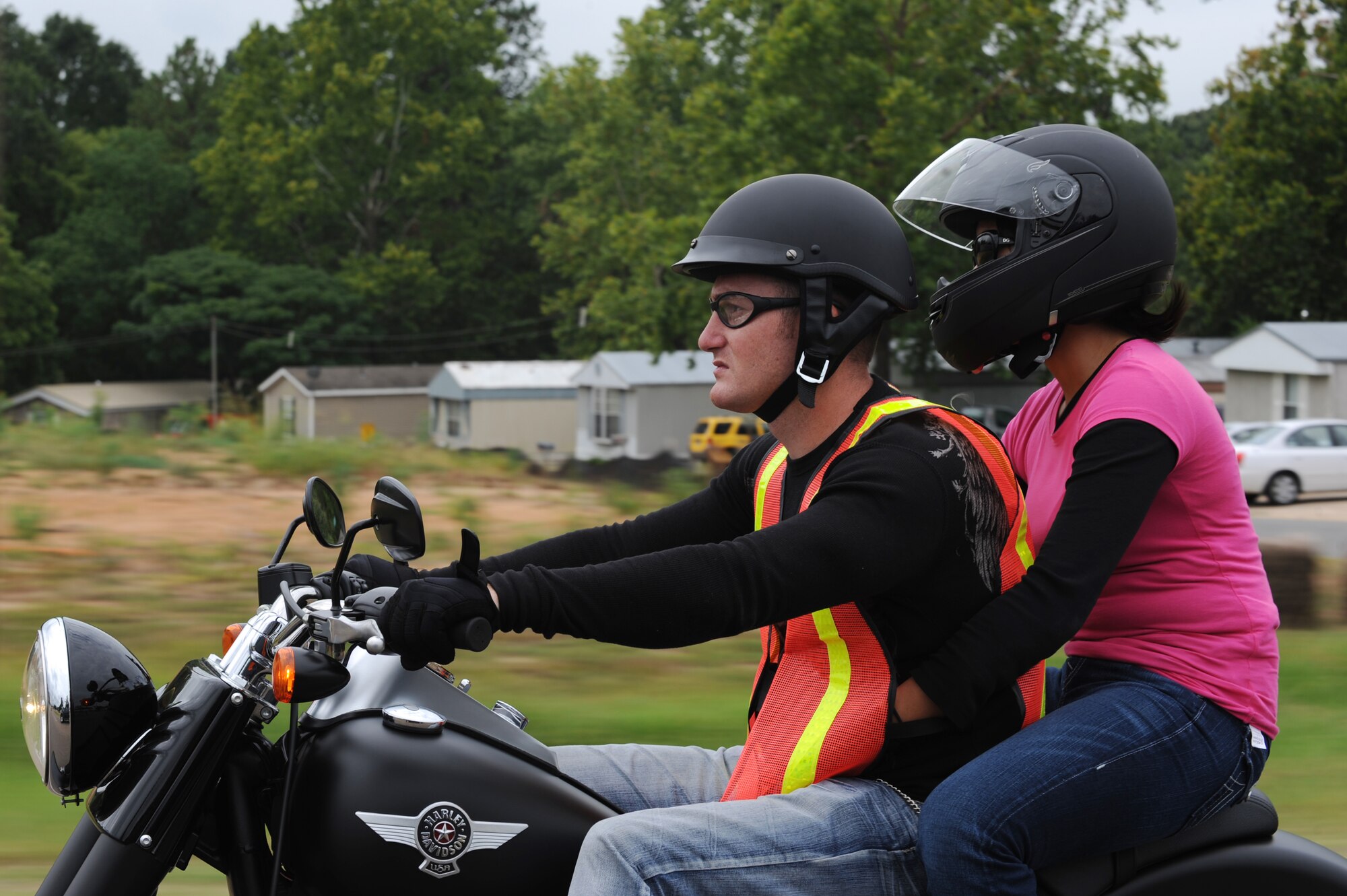 Participants of the Motorcycle Awareness and Remembrance Ride drive down East Texas Street in Bossier City, La., July 29. All active-duty riders and passengers must wear Department of Transportation or Snell approved helmets, full-fingered gloves, brightly colored backpacks, wrap-around eye wear and a reflective vest or brightly colored long-sleeve outer garment while riding on or off base. (U.S.  Air Force photo/Airman 1st Class Micaiah Anthony)(RELEASED)
