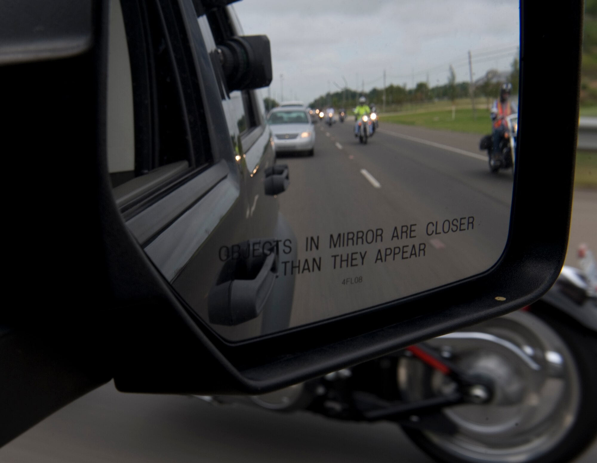 Participants of the Motorcycle Awareness and Remembrance Ride drive down East Texas Street in Bossier City, La., July 29. The event began with an hour-long briefing followed by a 71-mile ride that took the group 2 hours to complete.  (U.S.  Air Force photo/Airman 1st Class Micaiah Anthony)(RELEASED)