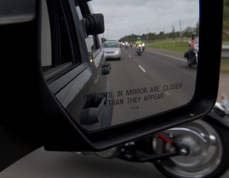 Participants of the Motorcycle Awareness and Remembrance Ride drive down East Texas Street in Bossier City, La., July 29. The event began with an hour-long briefing followed by a 71-mile ride that took the group 2 hours to complete.  (U.S.  Air Force photo/Airman 1st Class Micaiah Anthony)(RELEASED)