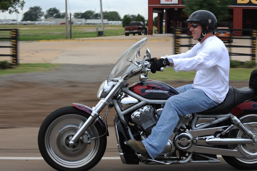A participant in the Motorcycle Awareness and Remembrance Ride drives down East Texas Street in Bossier City, La., July 29. More than 130 riders participated in the event. All appropriately trained motorcycle enthusiasts were able to participate in the ride. (U.S.  Air Force photo/Airman 1st Class Micaiah Anthony)(RELEASED)