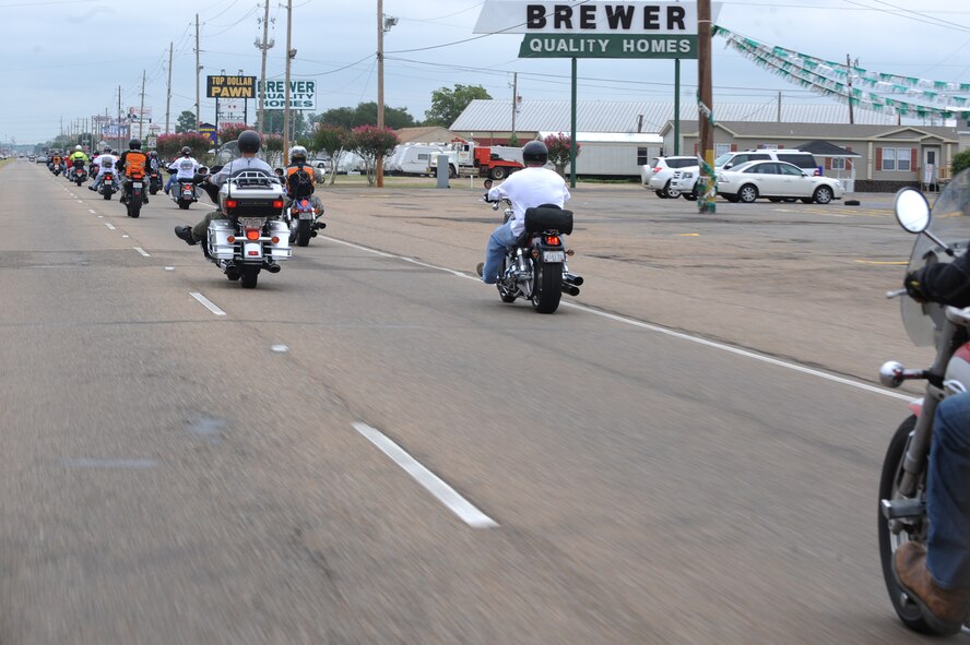 Participants in the Motorcycle Awareness and Remembrance Ride drive down East Texas Street in Bossier City, La., July 29. The event began with an hour-long briefing followed by a 71-mile ride that took the group 2 hours to complete.  (U.S.  Air Force photo/Airman 1st Class Micaiah Anthony)(RELEASED)