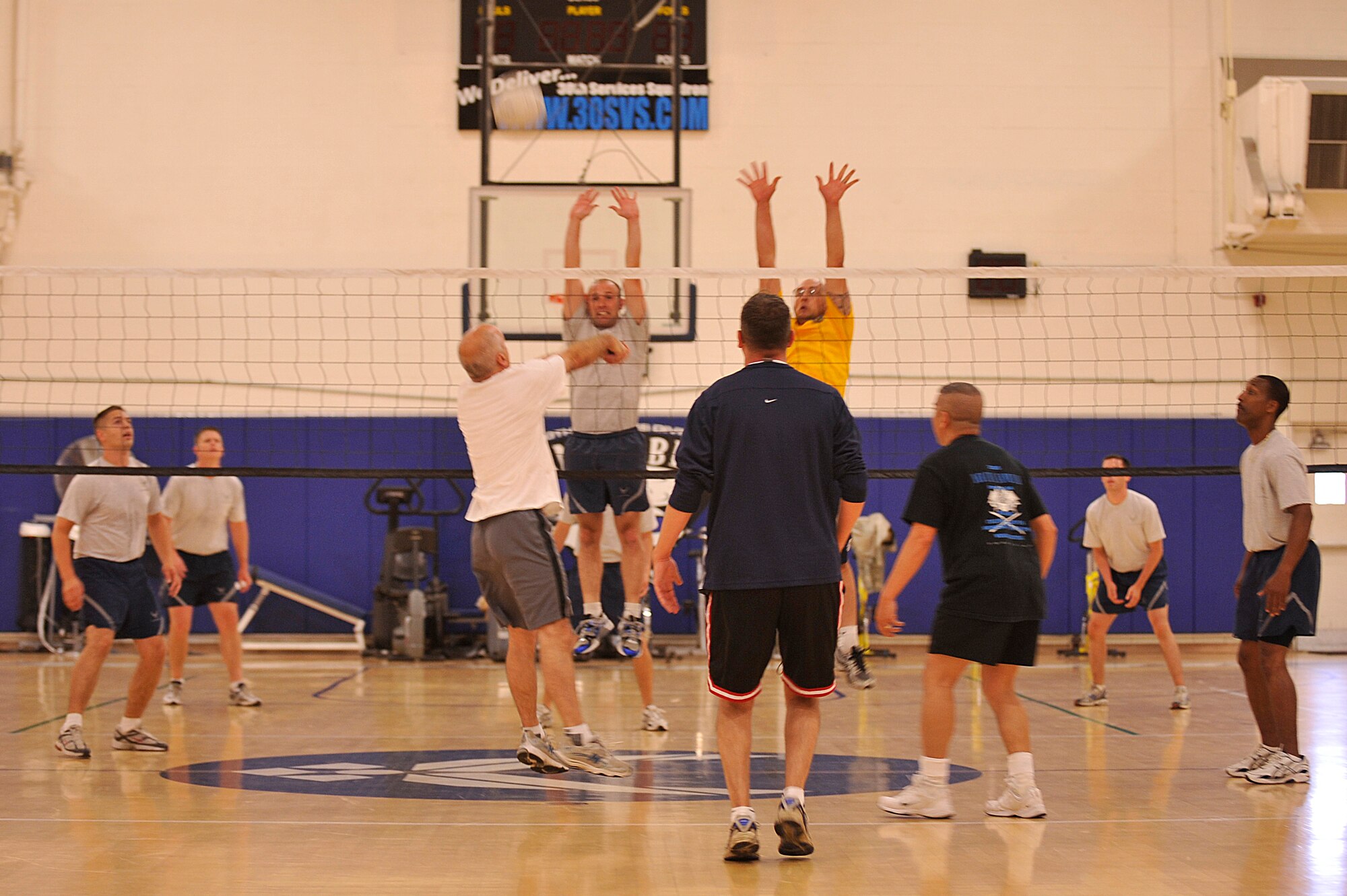 VANDENBERG AIR FORCE BASE, Calif. -- CGO members jump to block a volley from base leadership at the base gym Friday, July 29, 2011.  Vandenberg leadership faced off against Air Force lieutenants in a friendly athletic competition called Birds versus Bars. (U.S. Air Force photo/ Staff Sgt. Andrew Satran)