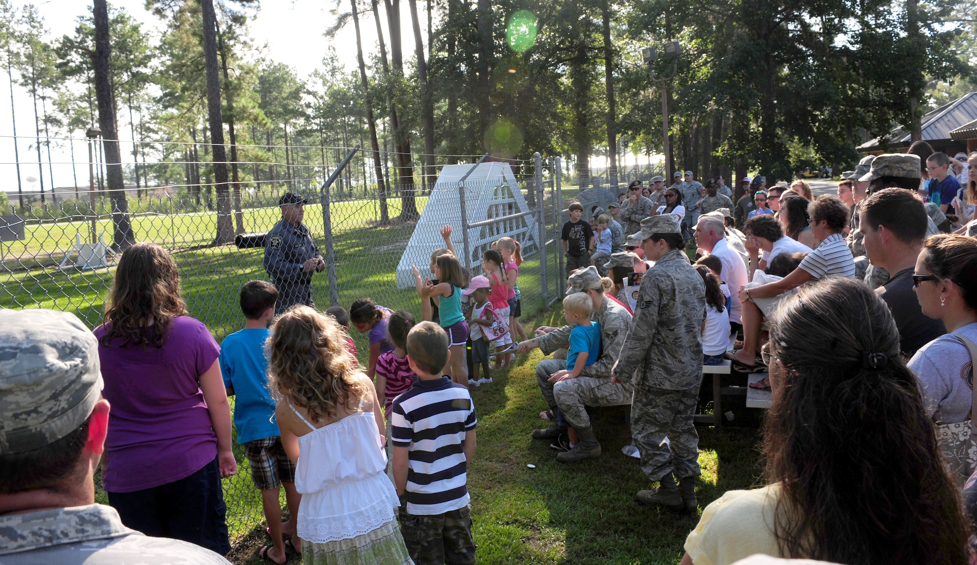 Many Airmen brought their children to watch the military working dog and local k-9 units demonstrate their capabilities during the Bring Your Child to Work Day at Moody Air Force Base, Ga., July 28, 2011. Watching the MWD demonstration is only one of the many activities that children and their parents were able to participate in throughout the day. (U.S. Air Force photo by Senior Airman Stephanie Mancha/Released)