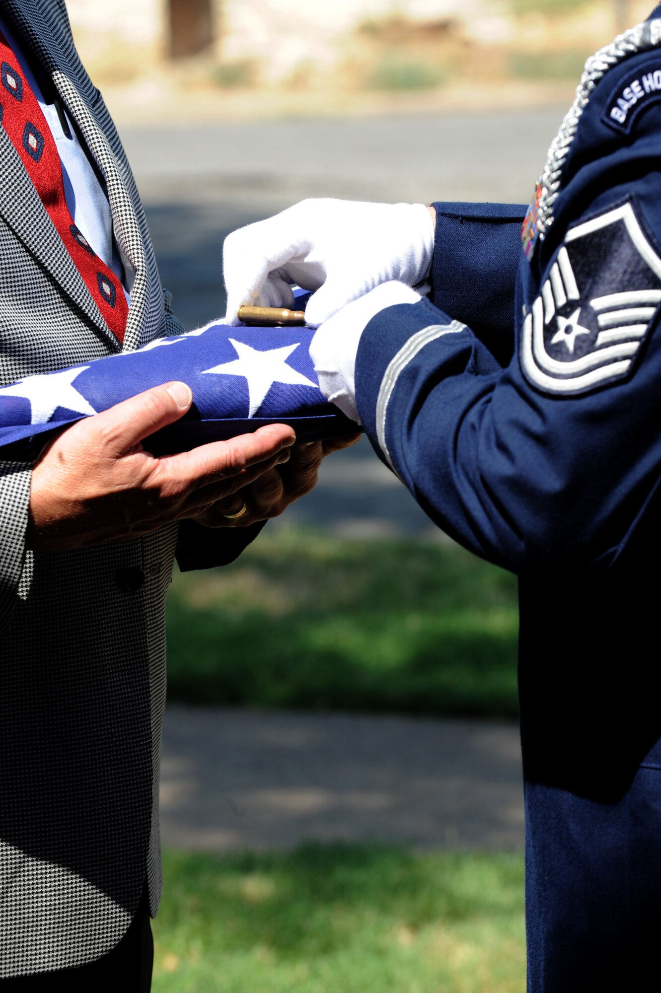 Shell casings are presented to next of kin July 29, 2011 during a funeral for retired Air Force Gen. Arthur Murray at St. Marry Catholic Church in West, Texas. After a 21- gun salute, shell casings are given to the next of kin representing Duty, Honor and Country. (U.S. Air Force photo by Airman 1st Class Jonathan Stefanko/ Released)