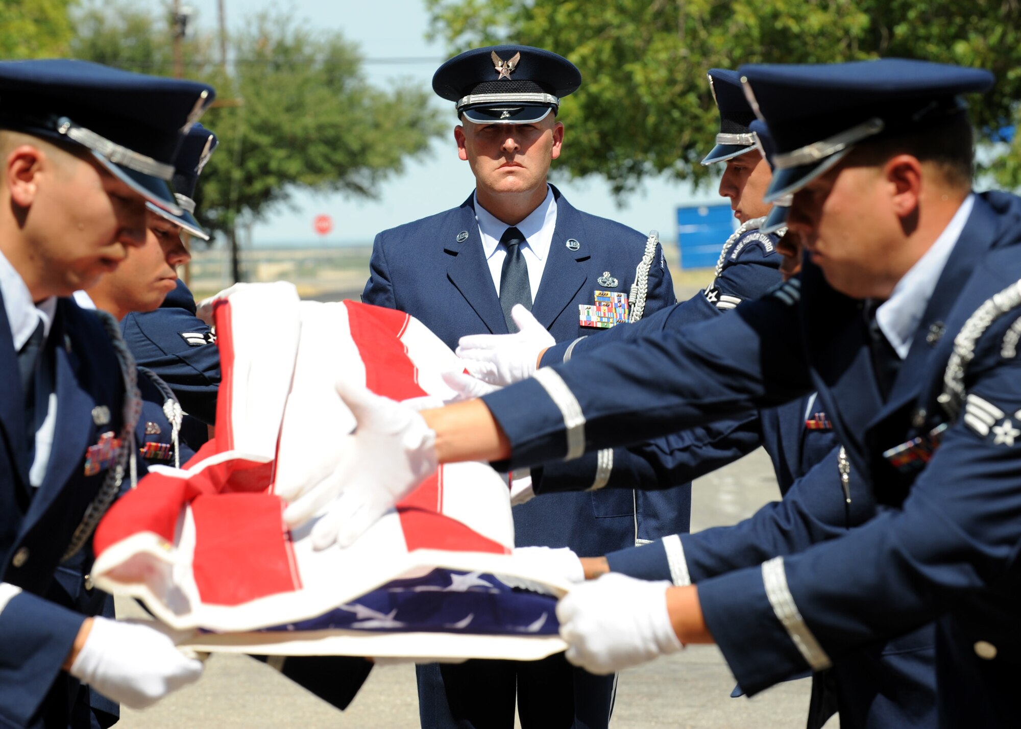 Dyess Air Force Base Honor Guard folds a flag July 29, 2011 during a funeral for retired Air Force Gen. Arthur Murray at St. Mary Catholic Church in West, Texas. Arthur is known to be the first test pilot to see the curvature of the Earth flying a Bell X-1A at 90,000 feet in 1954. (U.S. Air Force photo by Airman 1st Class Jonathan Stefanko/ Released)