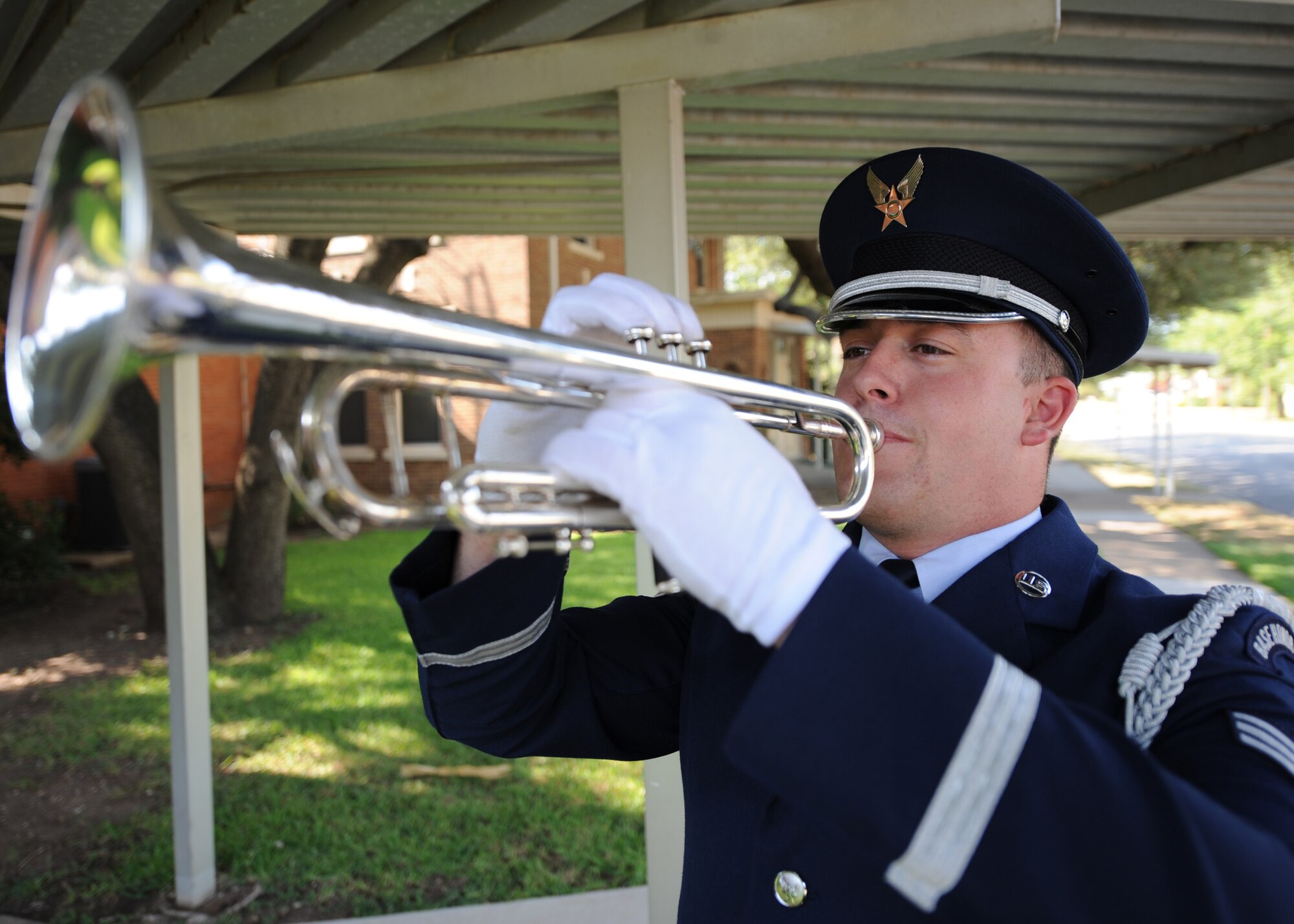 Senior Airman Zachary Montgomery, 7th Component Maintenance Squadron, plays taps July 29, 2011 during a funeral for retired Air Force Gen. Arthur Murray at St. Mary Catholic Church in West, Texas. Arthur is known to be the first test pilot to see the curvature of the Earth flying a Bell X-1A at 90,000 feet in 1954. (U.S. Air Force photo by Airman 1st Class Jonathan Stefanko/ Released)